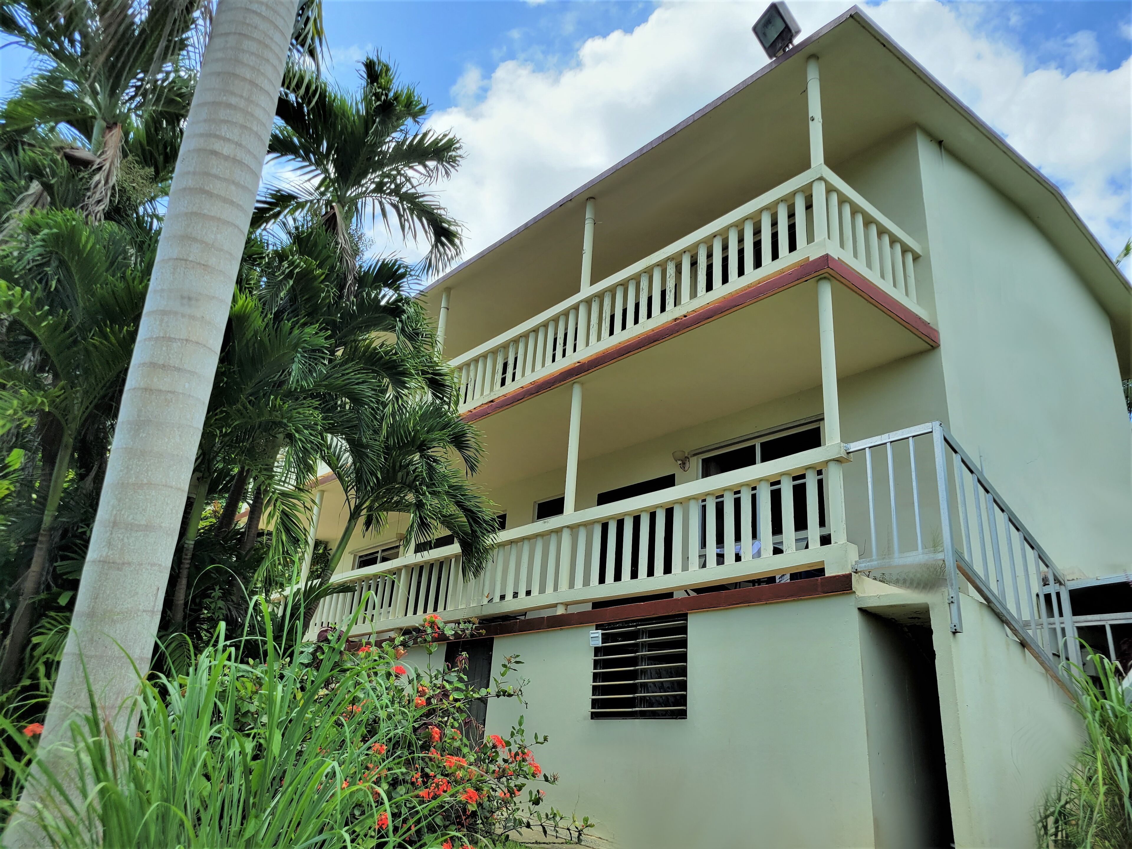 A two-story building with a balcony on the second floor.