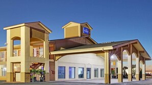 A hotel with a central atrium, multiple balconies, and a sign indicating it is a Marriott property. - Baymont by Wyndham Terrell (Terrell)
