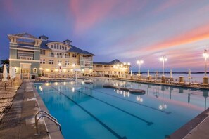 A large hotel with a swimming pool, multiple decks, and outdoor lighting. - SUNSET ISLAND Spacious 5-BR - TONS of Amenities (Ocean City)