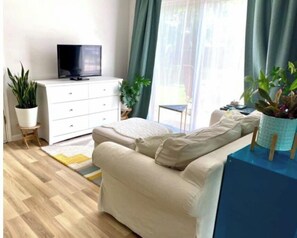 Relax in this stylish living room with a sofa, side table, and flat-screen TV.