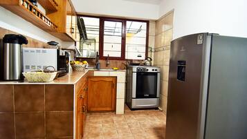 Geladeira, micro-ondas, fogão, talheres/pratos/utensílios de cozinha