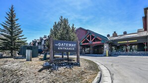A sign indicating the Gateway Entrance, with a building labeled 'Grocery Liquor' in the background. - Gateway Lodge 5037 (Keystone)