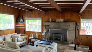 A cozy living room with a fireplace, wooden walls, and a sofa. - Bodega Bay - Sonoma Coastline (Bodega Bay)