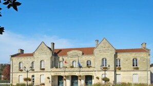 Un edificio histórico de piedra con una entrada central, con la inscripción 'MAIRIE' y 'LIBERTE FRATERNITE'.