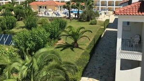 A resort with multiple buildings, a swimming pool, and lush greenery. - Village Inn Studios & Family Apartments (Zakynthos)