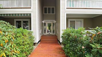 A building entrance with a sign reading "Glen Park" and a brick pathway leading to the door.