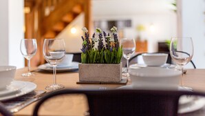 A dining table with a centerpiece of lavender flowers, clear wine glasses, and white plates. -  ByEvo Oswestry Barn - Quirky 2 Bed 1 Bath Barn style annex close to town centre (Oswestry)