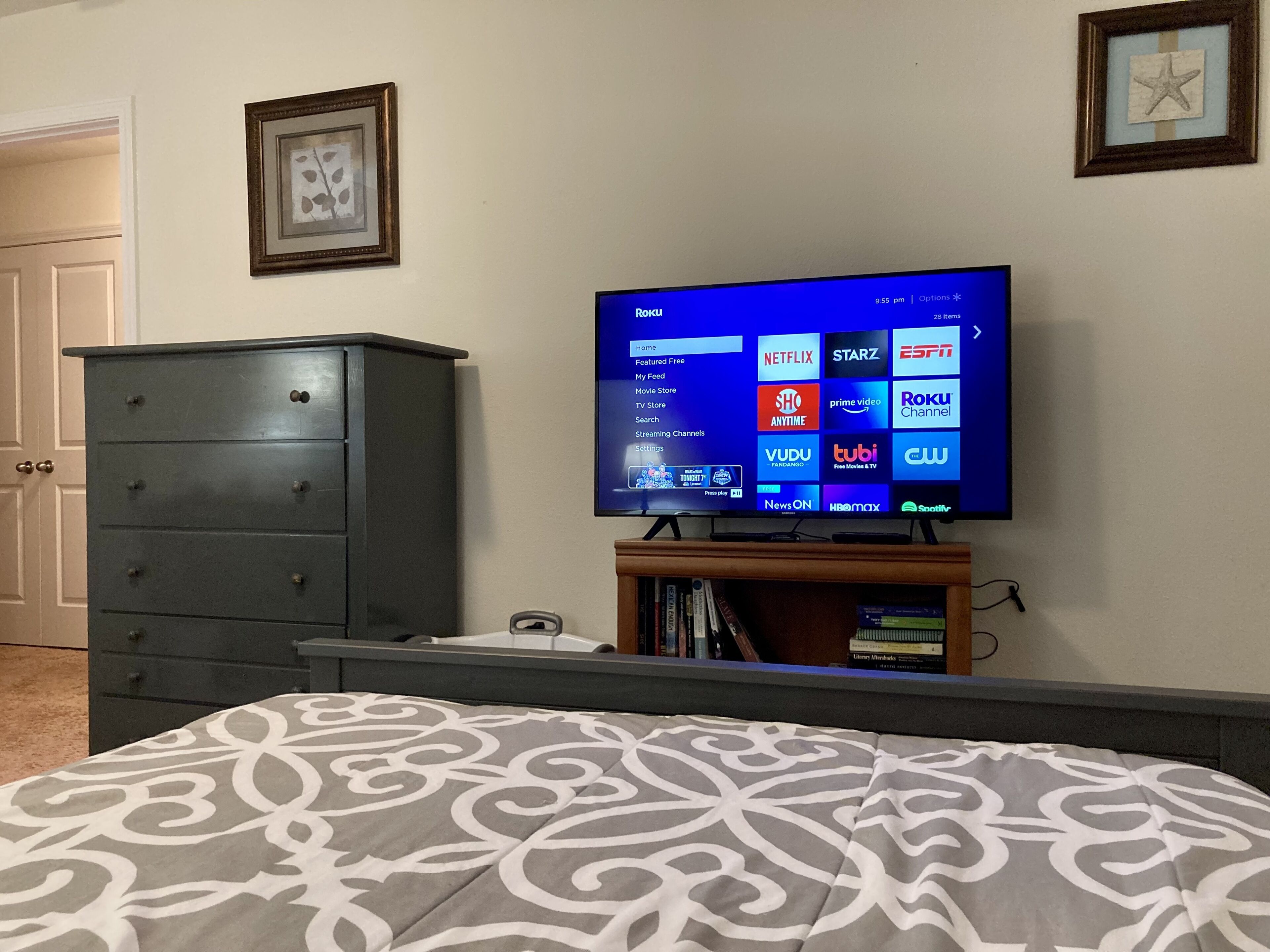 A bedroom with a bed, a dresser, and a television displaying a streaming service interface. - Quiet Area * Private Bedroom & Bath * Ideal Location (Charlotte)