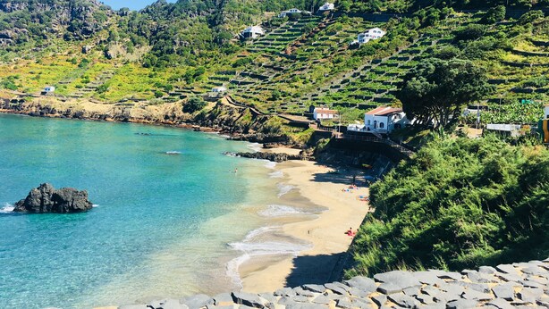 A coastal area with terraced houses, a beach, and a rocky shoreline. - Villa Mariense welcomes you in a landscape designed by nature! (Santa Barbara - Santa Maria - Azores Island)