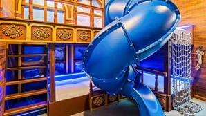 A room with a large blue drum, wooden paneling, and a nautical-themed decor.
