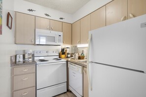 Condo, 2 Bedrooms | Private kitchen | Stovetop, toaster, cookware/dishes/utensils, dining tables