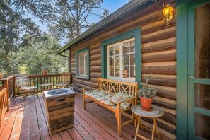 A wooden cabin with a deck, a bench, a table, and a potted plant. - Wine Gazebo Pikes Peak Mountain Log Cabin (Cascade-Chipita Park)