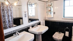 Tina con regadera, secadora de cabello, bidet, toallas 