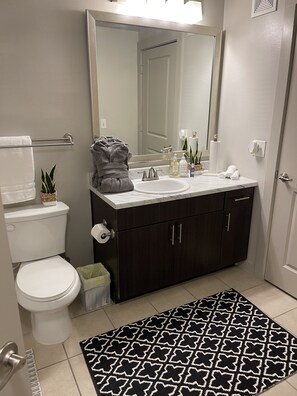 Combined shower/bathtub, towels, soap, toilet paper