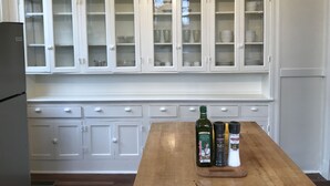 A kitchen with white cabinets and a wooden countertop. - Spacious Home and Private Getaway (Fayette)
