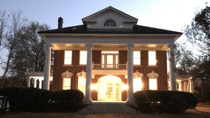 A large brick building with a central entrance, flanked by columns, and a symmetrical facade. - Spacious Home and Private Getaway (Fayette)