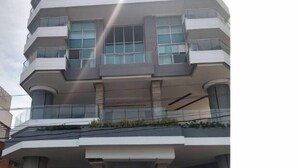 A multi-story building with a modern architectural design, featuring balconies and large windows. - Apartamento Vista al Mar (Cartagena)