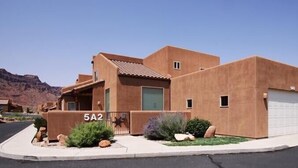 A modern two-story house with a flat roof, a garage, and a number '5A2' sign. - Beautiful Moab Townhome (moab)