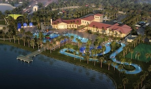 An aerial view of a resort with multiple swimming pools, palm trees, and a large building with a red roof.