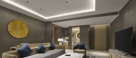 A modern living room with a sofa, coffee table, and a TV.