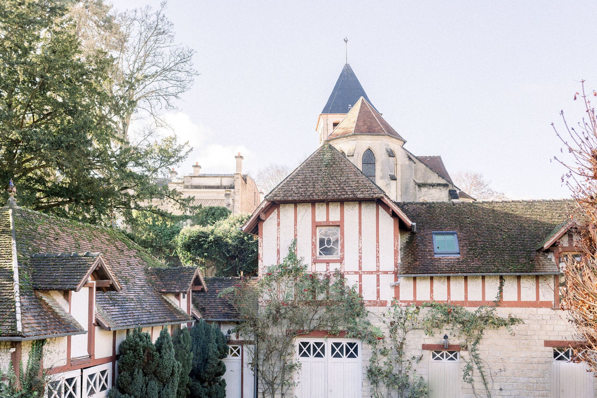 A traditional half-timbered building with a steeply pitched roof and a prominent tower.