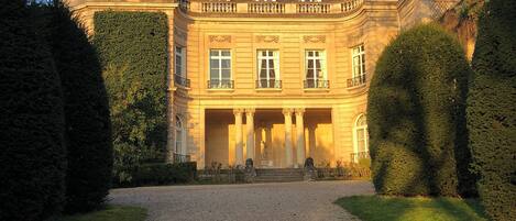 A large, classical building with a symmetrical facade, columns, and a central entrance.