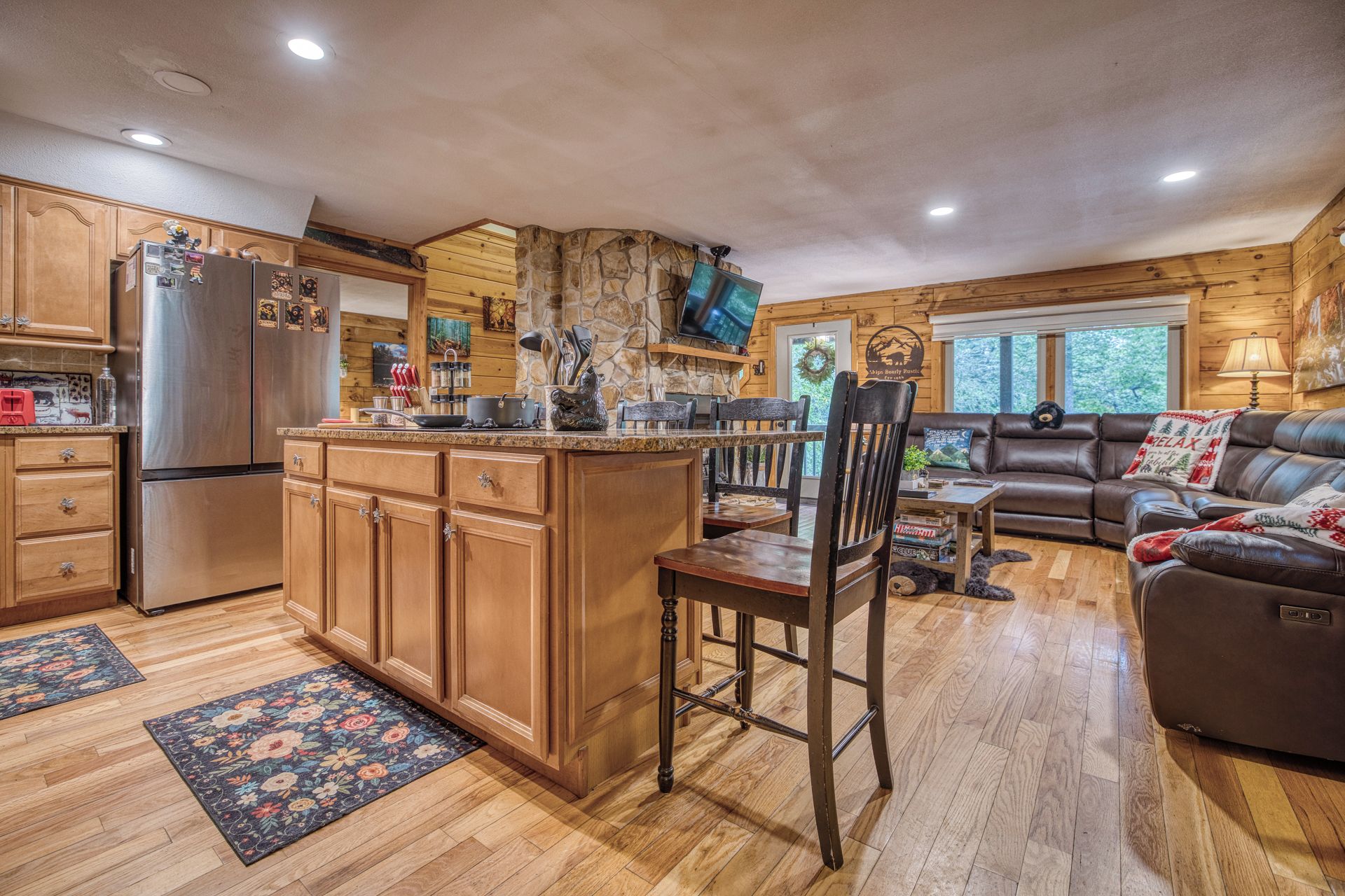 A cabin interior with a kitchen, dining area, and living room.