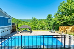 A swimming pool with a fenced deck, a gazebo, and a view of green hills. - Heated Private Saltwater Pool; Hot Tub; 15 min AVL; 10 min Blue Ridge Parkway (Candler)