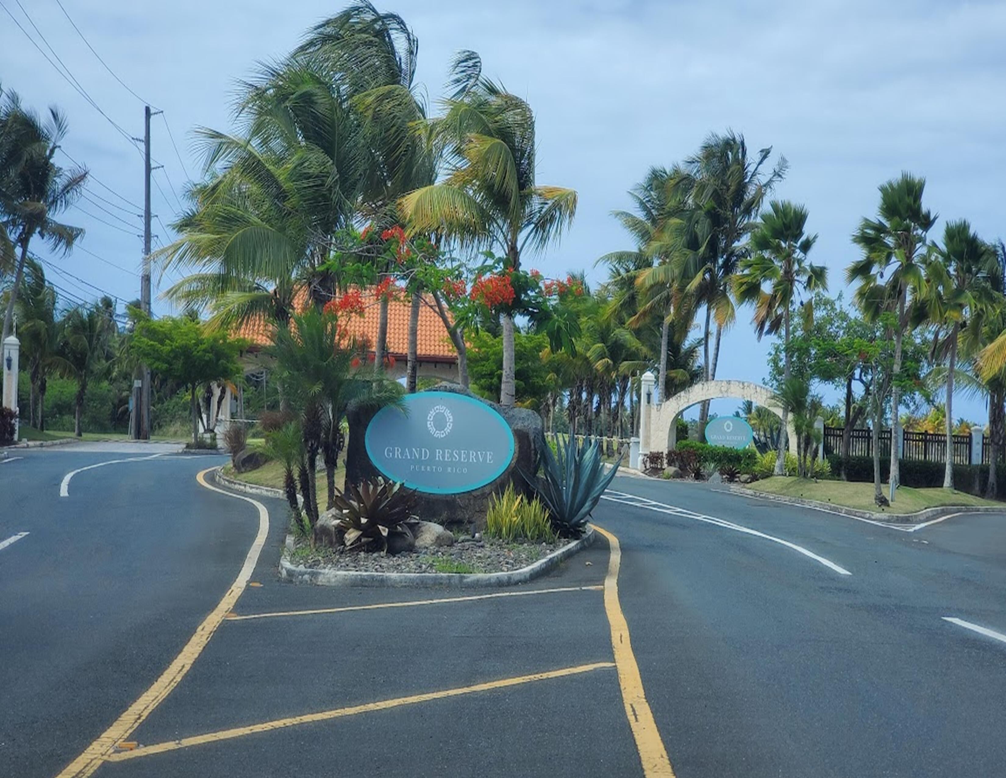 A road leading to a sign for Grand Reserve in Puerto Rico.