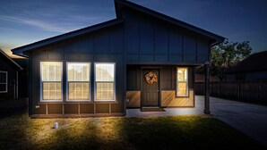 A modern two-story house with large windows, a front door with a wreath, and a number '2316' on the post. - The Silo Sweetheart- Just minutes from Downtown! (Waco)