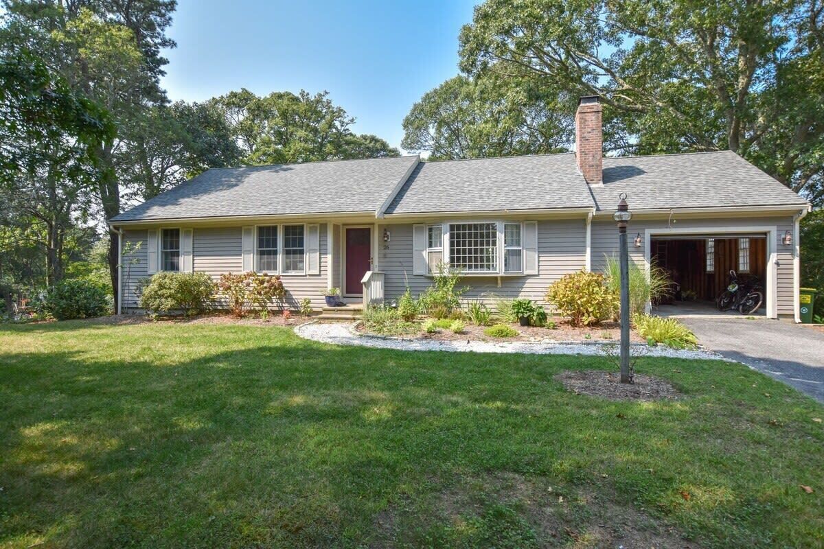A single-story house with a garage, a front porch, and a well-maintained lawn.