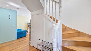 A staircase with white balusters and wooden steps leading to a landing. - Picture Perfect on Pier (INVERLOCH)