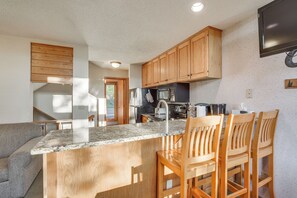 Enjoy cooking and dining in this well-equipped kitchen with a central island and bar seating.