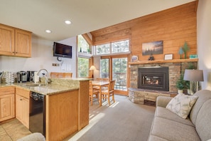 Enjoy a spacious kitchen and living area with a large island, comfortable sofa, and fireplace.