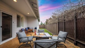 A patio with a fire pit, outdoor furniture, and a view of the backyard. - Family-Friendly Home Near Vineyards & Dtwn Newberg (Newberg)