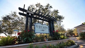 A gated entrance with a sign reading "Lucaya Village" and the number "3040".