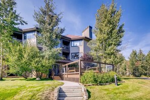A modern two-story house with a covered porch, surrounded by trees and a well-maintained lawn. - Platinum Frost Fire, Hot Tub access, Near Slopes! (Keystone)
