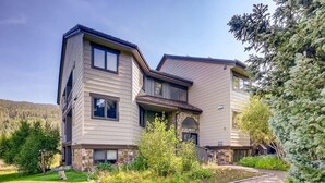 A modern two-story house with a stone foundation, large windows, and a well-maintained garden. - Platinum Frost Fire, Hot Tub access, Near Slopes! (Keystone)