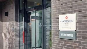 The entrance to Candlewood Suites by IHG in Berlin, featuring glass doors and a welcome sign. - Candlewood Suites Berlin Charlottenburg by IHG (Berlin)