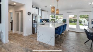 A modern kitchen with a central island, stainless steel appliances, and a view to the outdoors. - Perfectly located in Scottsdale to ALL  (Scottsdale)