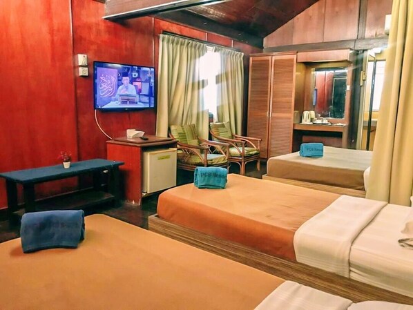A hotel room with two beds, a television, a desk, and a chair. - PCB Beach Resort (Kota Bharu)