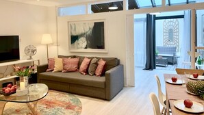 A modern living room with a sofa, a coffee table, and a dining area with a table and chairs. - Huge & Central 3 Bedr/4 Beds/2,5 Bath/ Covent Gdn (Greater London)