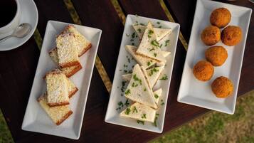 A table with three rectangular plates containing food items.