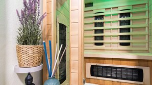 A room with a woven basket on a shelf, a blue vase with sticks, a Buddha statue, a heater, and a patterned rug. - Modern family&pet friendly villa with private sauna and beach (Bosljiva Loka)