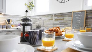 A breakfast setting with croissants, orange juice, and a coffee maker on a modern kitchen counter. - Bay View - Amazing Location ,dog friendly, 10 mins to the beach and town. (Scarborough)
