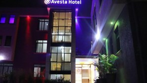 The exterior of the Avesta Hotel with a modern facade, large windows, and a sign indicating the hotel's name. - Avesta Hotel (Kampala)