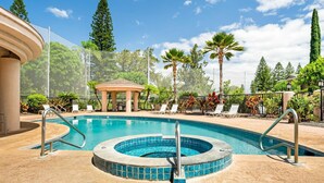 A swimming pool with a hot tub, surrounded by palm trees and lounge chairs. - Summer Deal Golfers Paradise Condo with Fairway and Ocean Views (Waikoloa)