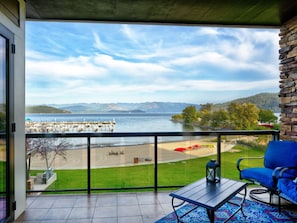 A balcony with a view of a lake, dock, and mountains. - Bikes & Kayaks, Waterfront - Seasons at Sandpoint (Sandpoint)