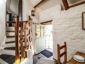 A staircase with wooden railings leading to a door with a light green frame. - Y Felin at Coed Cadw (Crymych)
