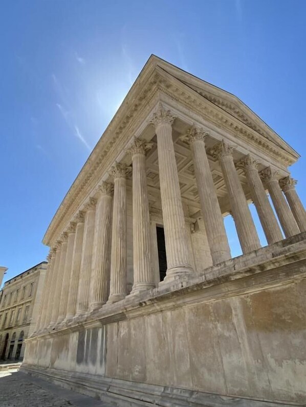 A classical building with a triangular pediment and fluted columns.